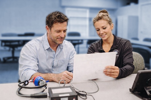 Technician explaining test results to a patient