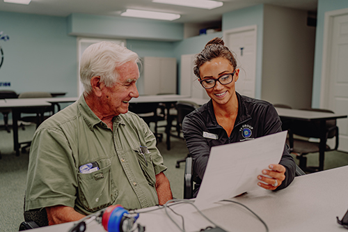 Technician explaining test results to worker