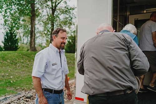 Workers entering hearing testing mobile unit