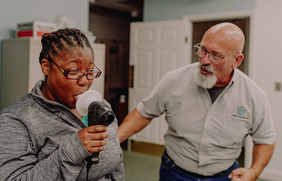 Woman taking pulmonary function test